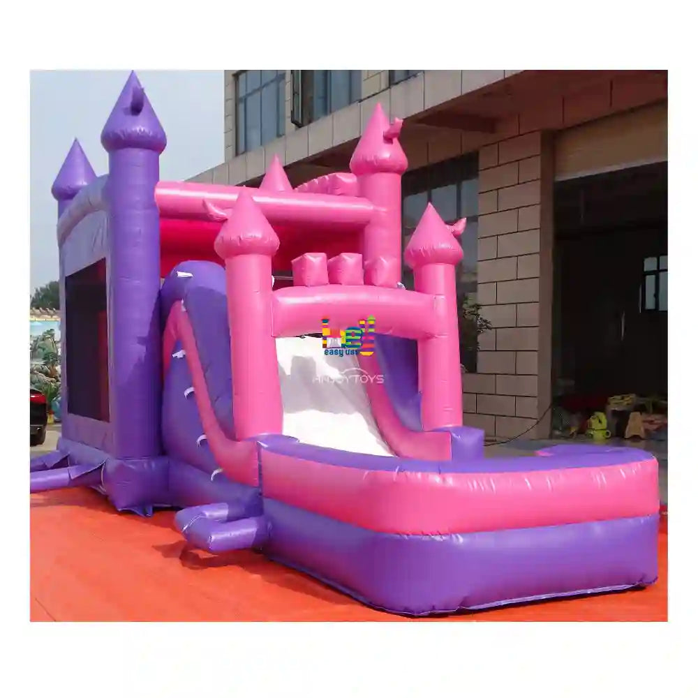 Front outdoor view of a purple-and-pink wet dry inflatable combo with castle towers, slide, and attached landing pool