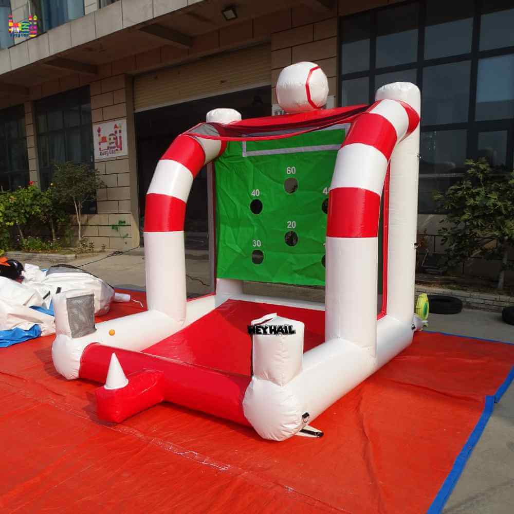 Outdoor angled view of baseball toss game showing the open front and striped columns