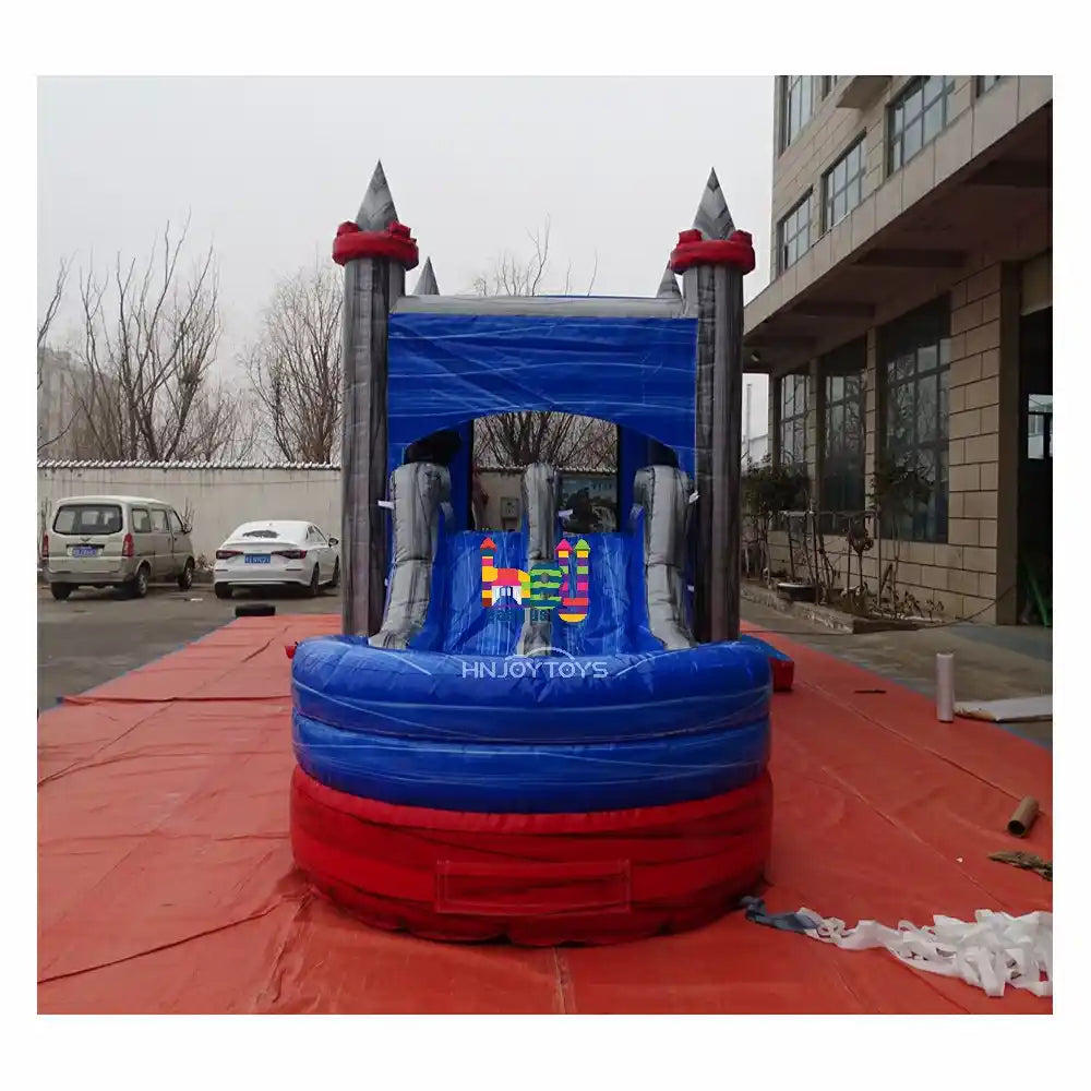 Outdoor front view of a marble-blue and gray inflatable castle combo with a dual-lane slide