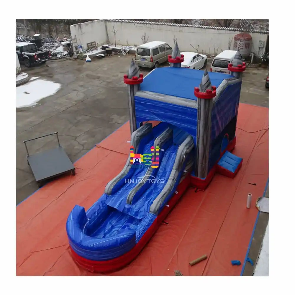 Outdoor elevated front view of a marble-blue and gray inflatable castle combo with a dual-lane slide