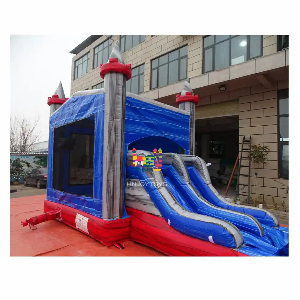 Outdoor angled view of a marble-blue and gray inflatable castle combo with a dual-lane slide