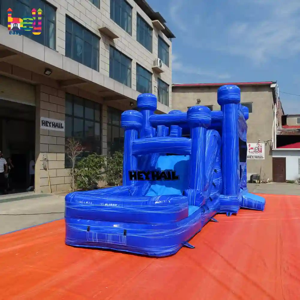 Outdoor rear view of a marble-blue inflatable castle combo