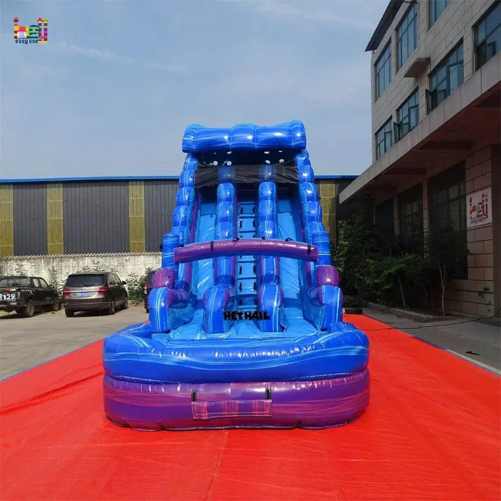 Front view of a marble blue-and-purple dual-lane inflatable water slide with a round landing pool on a red ground cover