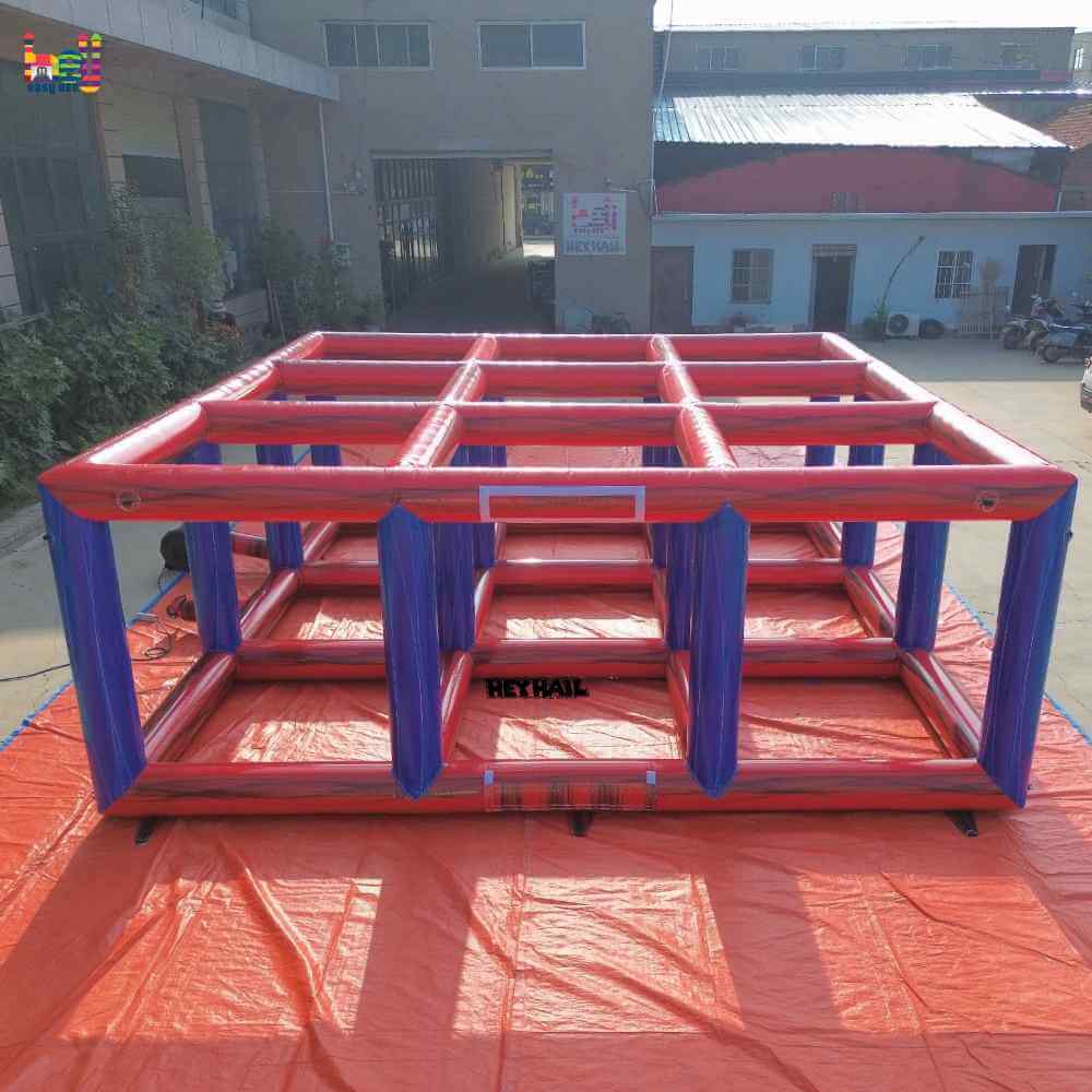 Outdoor front view of red-and-blue inflatable volleyball frame with a three-by-three overhead grid