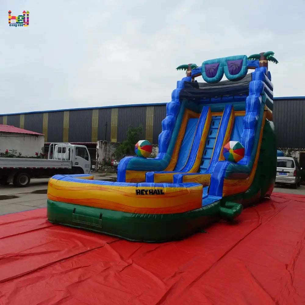 Factory three-quarter view of blue and green 20ft dual-lane water slide with landing pool
