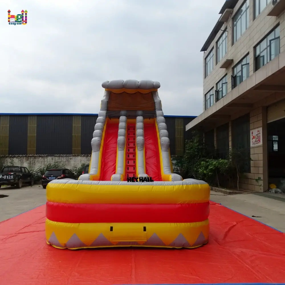 Front outdoor view of a yellow-and-gray 22ft dual-lane inflatable water slide with a rectangular landing pool