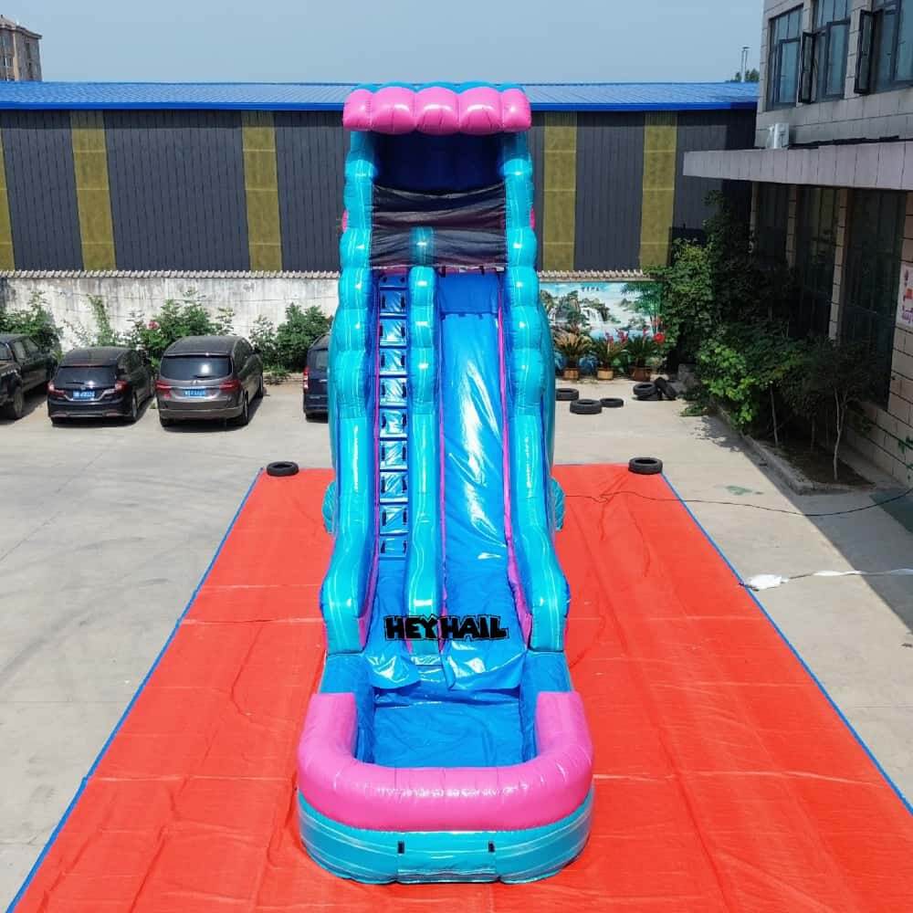 Pink and blue 22ft single lane water slide with landing pool, front view