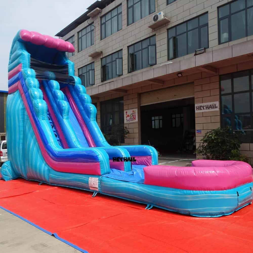 Side view of pink and blue 22ft single lane water slide with landing pool
