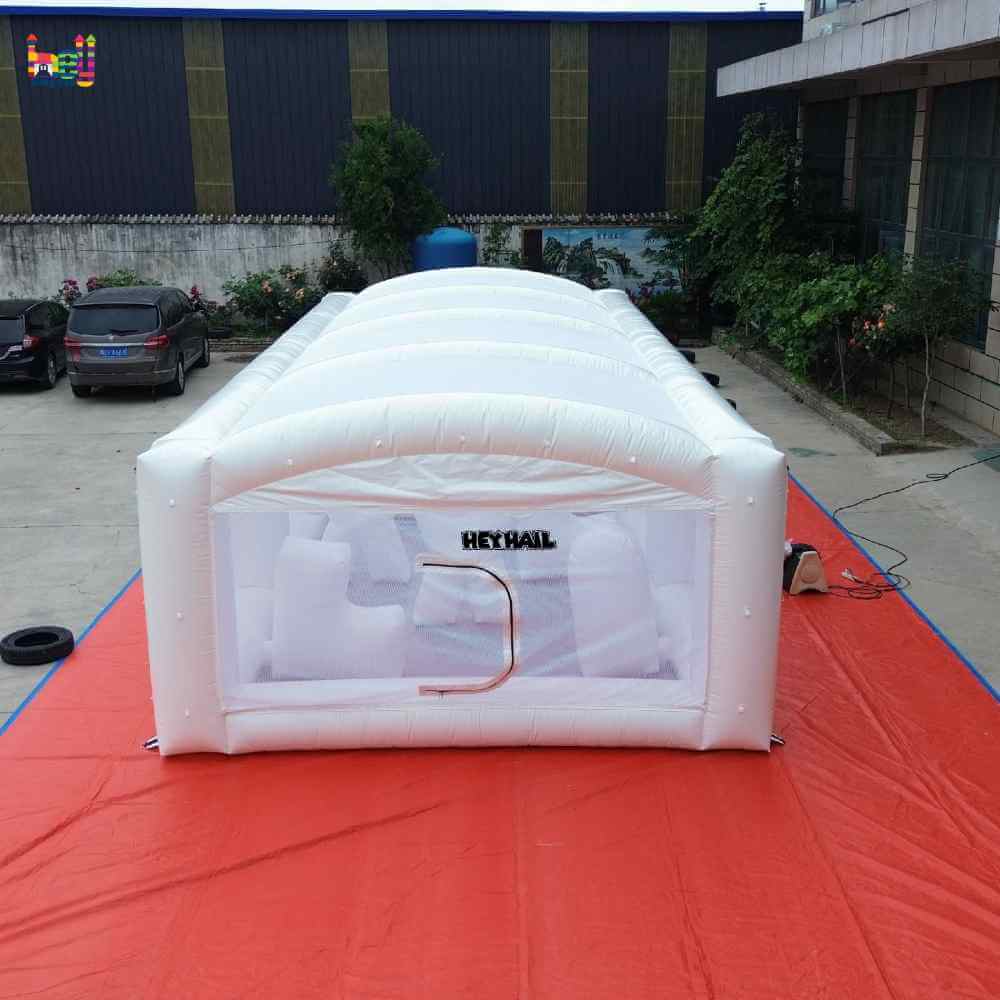 End view of white enclosed inflatable obstacle course with arched roof supports