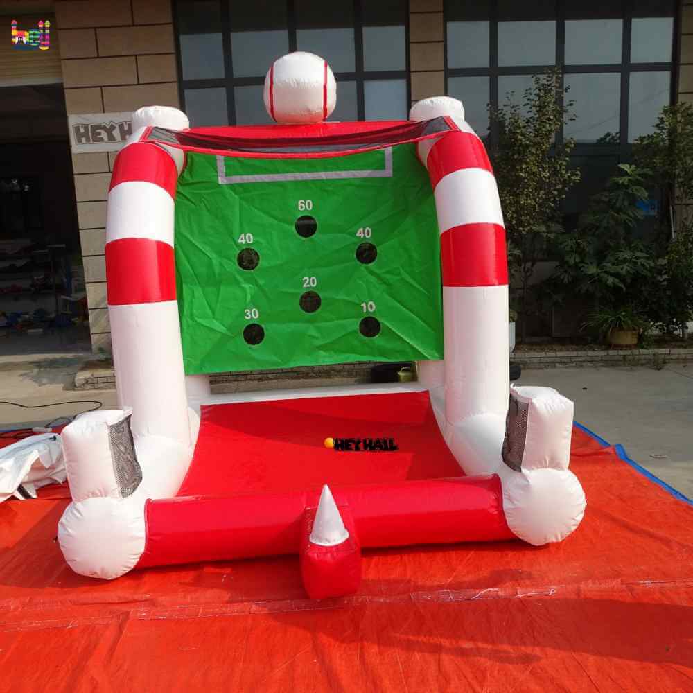 Front view of red-and-white inflatable baseball toss game with six numbered targets