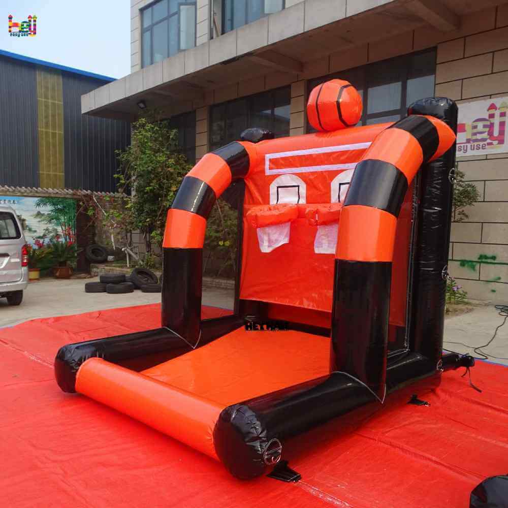Outdoor angled view of orange-and-black dual-hoop inflatable basketball shooting game