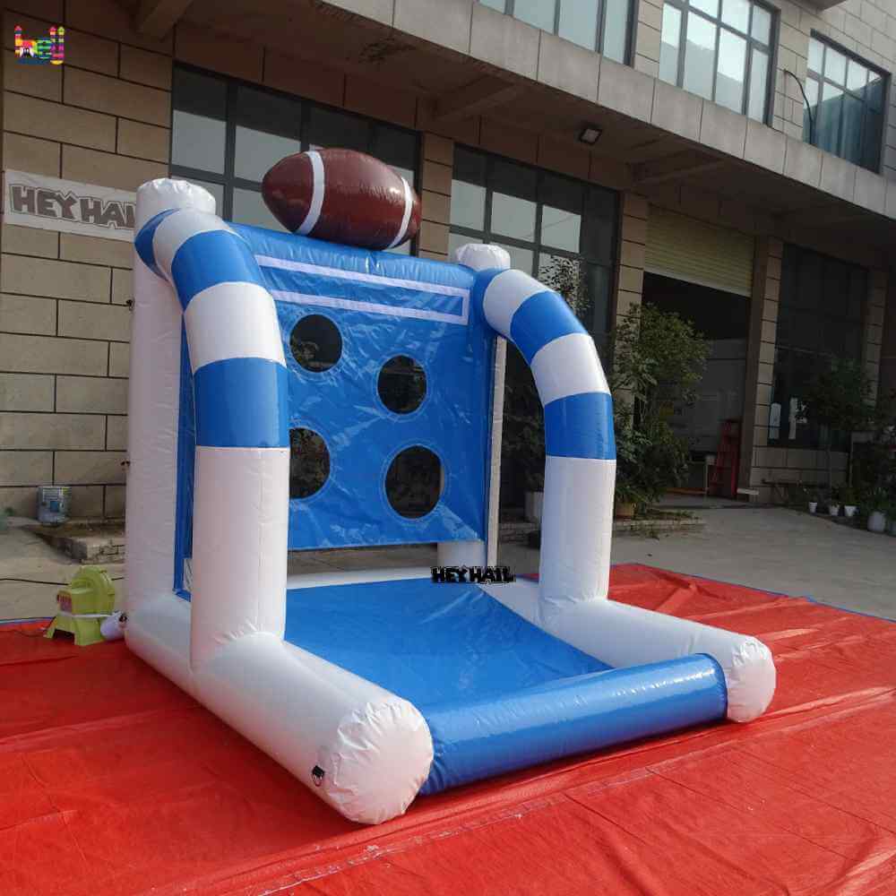 Outdoor angled view of inflatable football throwing game with football top decoration