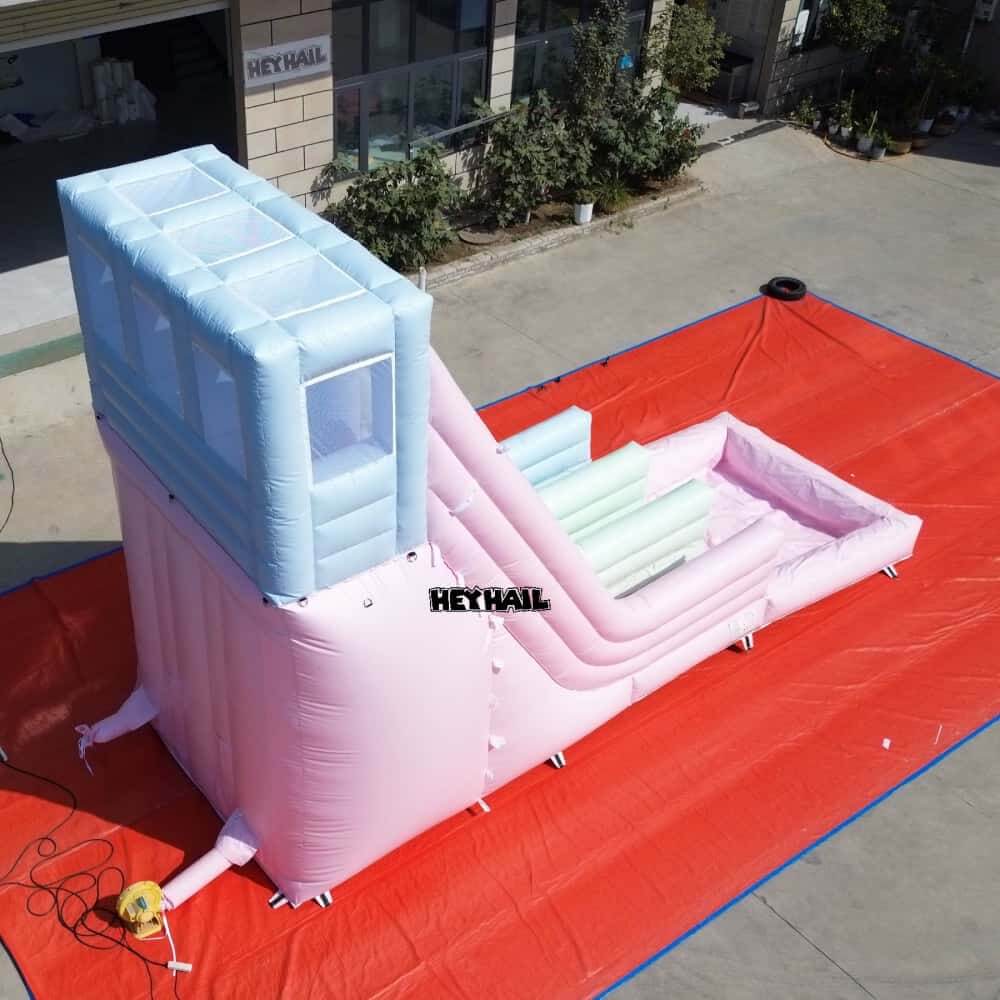 Pastel dual lane water slide rear view with climbing steps and splash pool