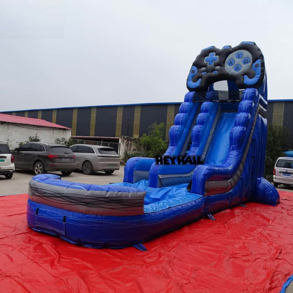 Angled factory view of blue single lane commercial water slide with splash pool