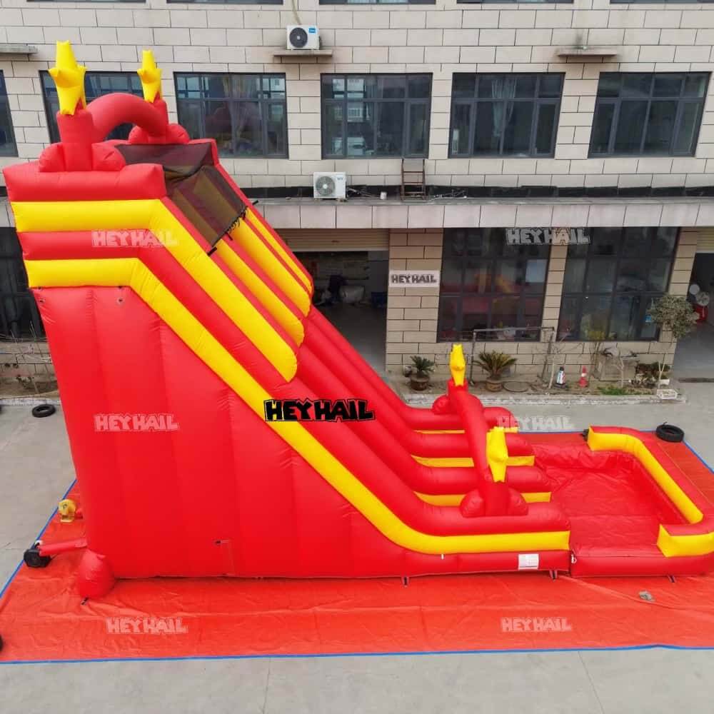 Side view of red and yellow HJSW-082 dual-lane commercial water slide with splash pool