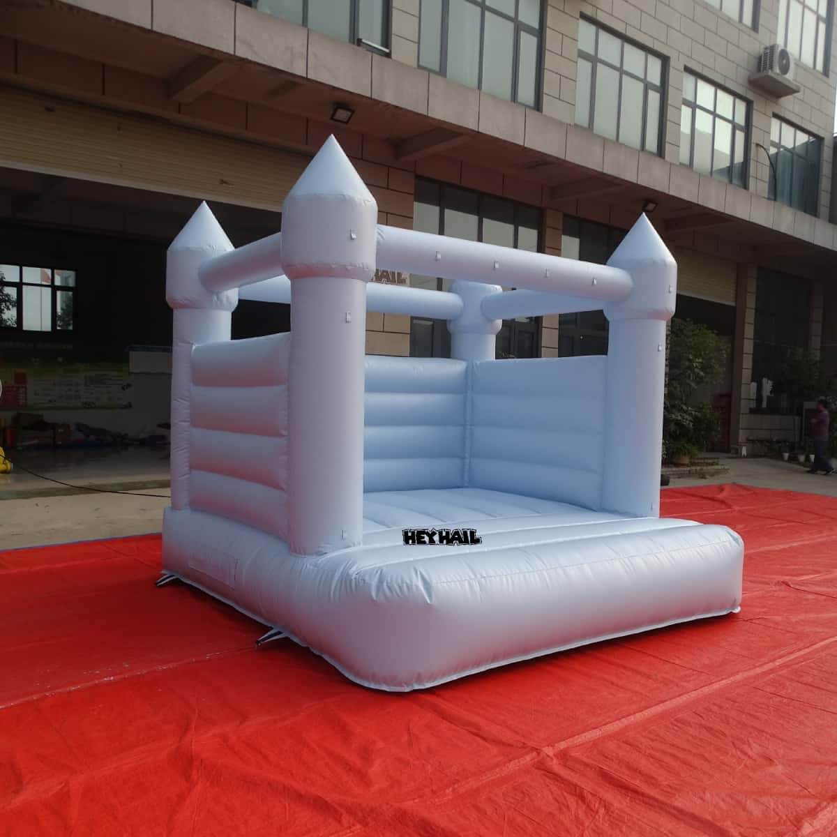 Light pastel blue bounce house front angled view