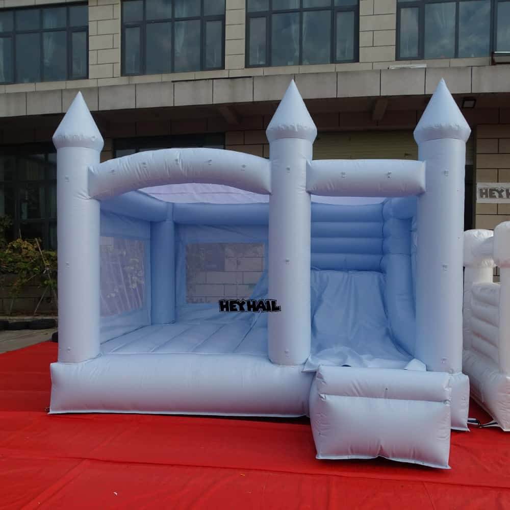 Front view of light pastel blue 13 x 13 ft bounce house with slide