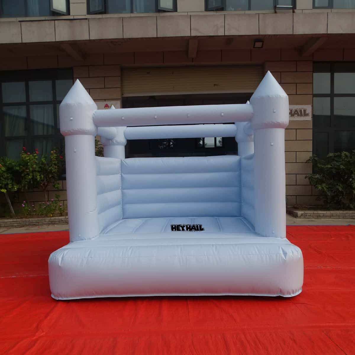 Light pastel blue bounce house front view