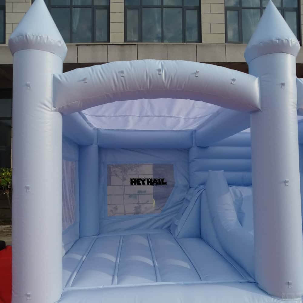 light pastel blue bounce house with slide