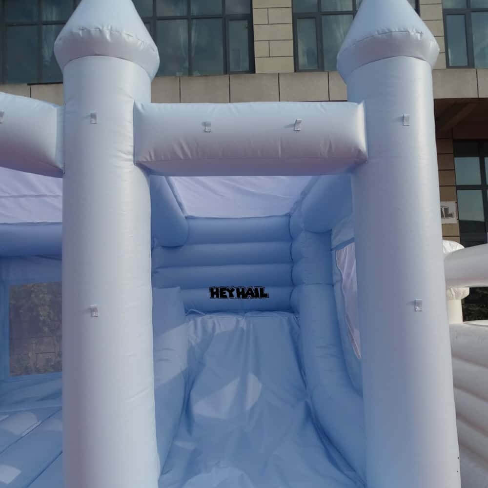 Close view of attached slide on light pastel blue bounce house
