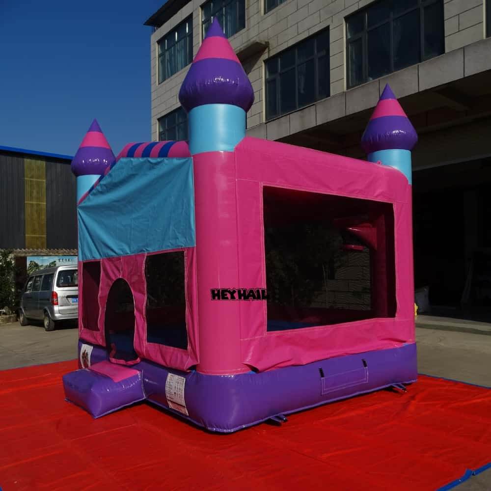 Pink 13 x 13 ft regular bounce house with purple castle turrets